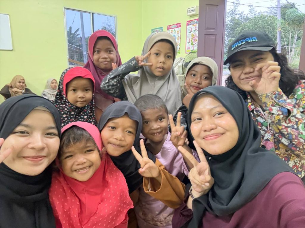 Volunteers and community members participating in an Orang Asli community outreach activity in Sungai Siput, Perak.