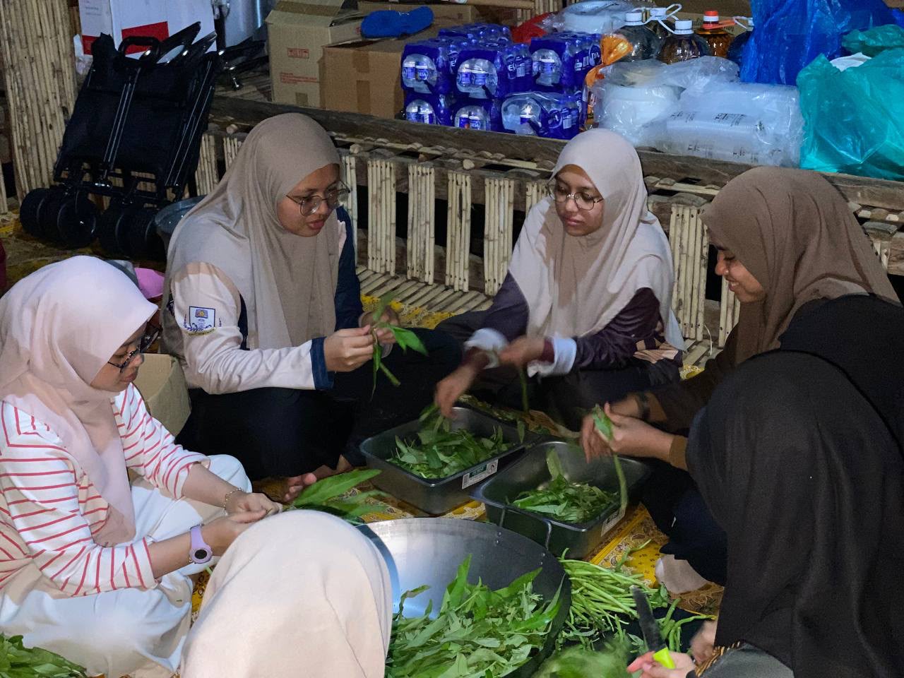 Volunteers preparing fresh vegetables for a community food programme supporting the Orang Asli community in Sungai Siput, Perak.